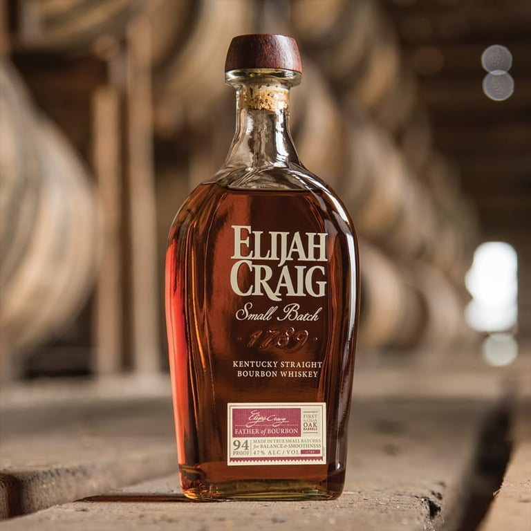 Bottle of Elijah Craig Small Batch Kentucky Straight Bourbon Whiskey displayed on wooden surface with blurred wooden background