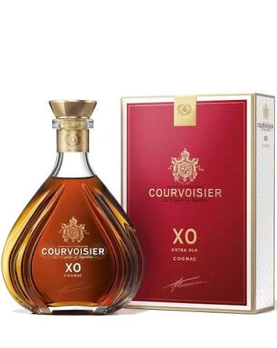 Bottle of Courvoisier XO cognac next to its red and gold packaging box