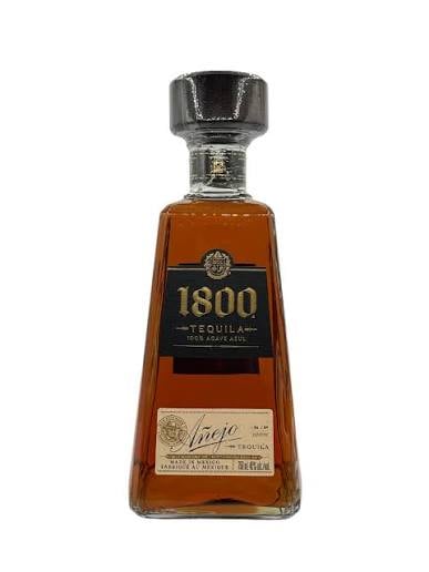 Bottle of 1800 Tequila with dark label and amber liquid against white background