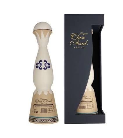 Clase Azul Añejo tequila bottle with blue floral design next to its black packaging box