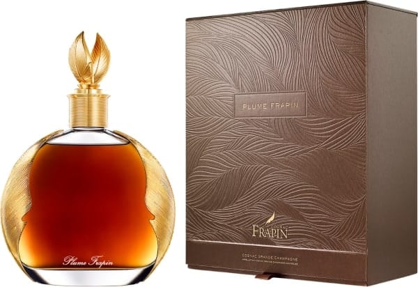 Luxury cognac bottle with gold leaf stopper next to decorative brown box packaging