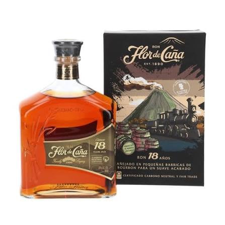 Flor de Cana 18-year-old rum bottle and its decorative box packaging featuring volcano imagery