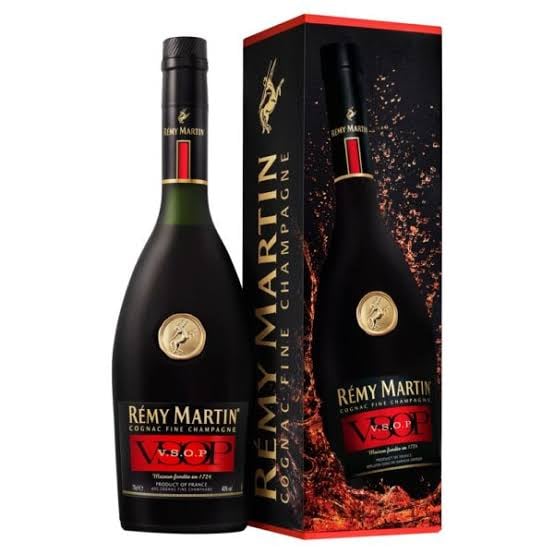 Remy Martin VSOP cognac bottle next to its decorative gift box with red accents and gold branding
