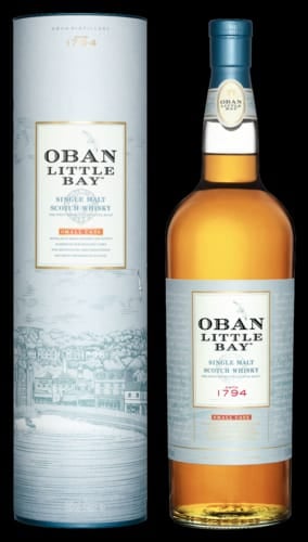 Bottle and cylindrical packaging of Oban Little Bay single malt Scotch whisky against a black background